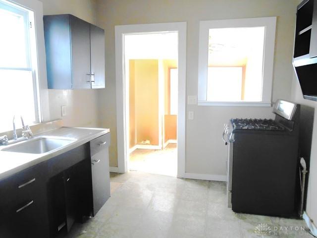 kitchen featuring sink, plenty of natural light, and stainless steel range with gas stovetop