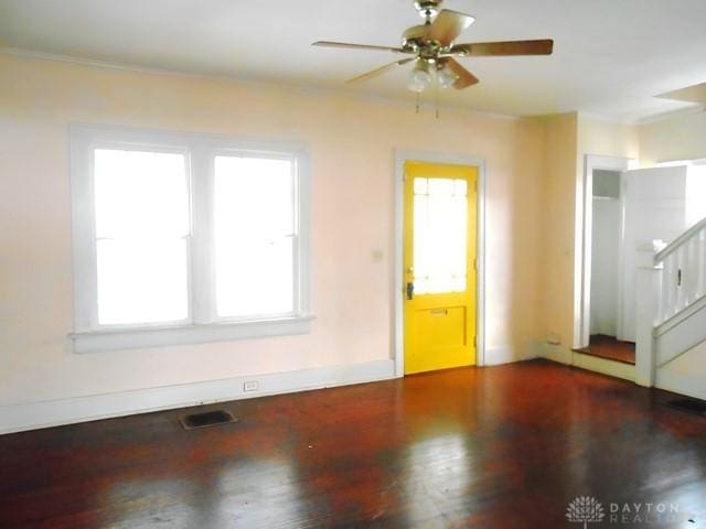 unfurnished room with ceiling fan and a wealth of natural light