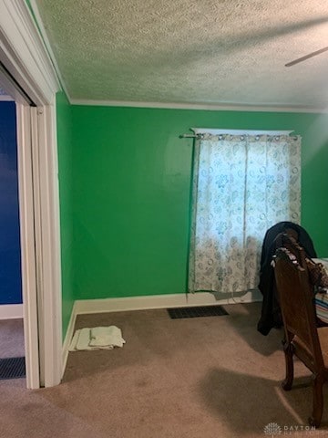 office featuring a textured ceiling, ceiling fan, and carpet floors