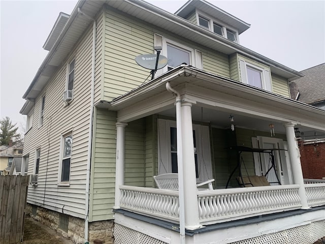 view of side of property featuring covered porch