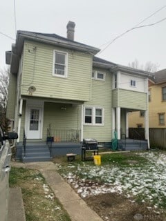 rear view of property with covered porch