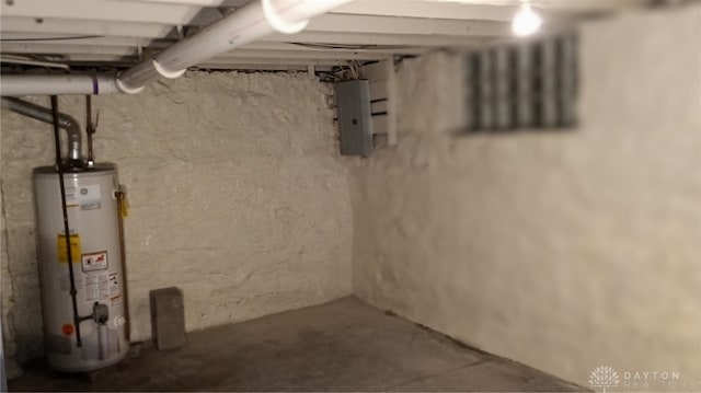 basement featuring electric panel and gas water heater