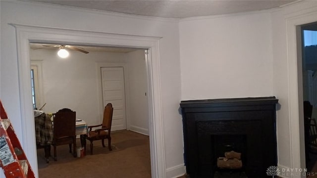 carpeted dining area with ornamental molding, ceiling fan, and a fireplace