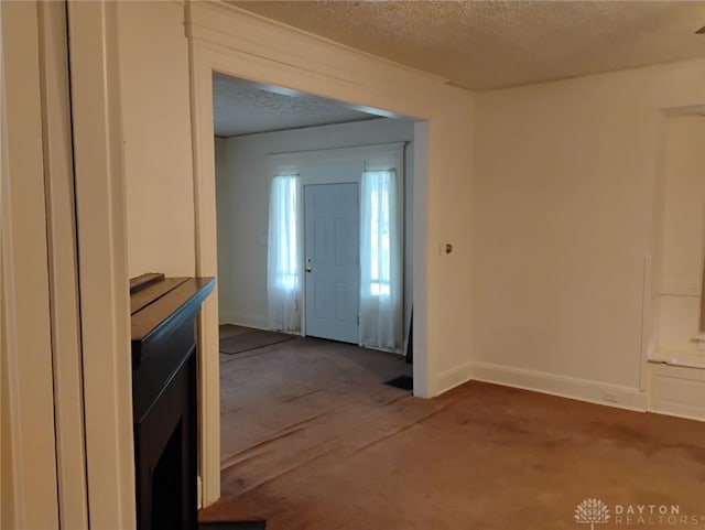 interior space with baseboards and a textured ceiling