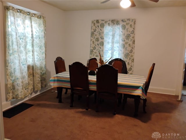 dining room featuring a ceiling fan, carpet flooring, and baseboards