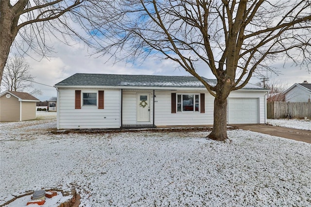 single story home featuring a storage unit and a garage