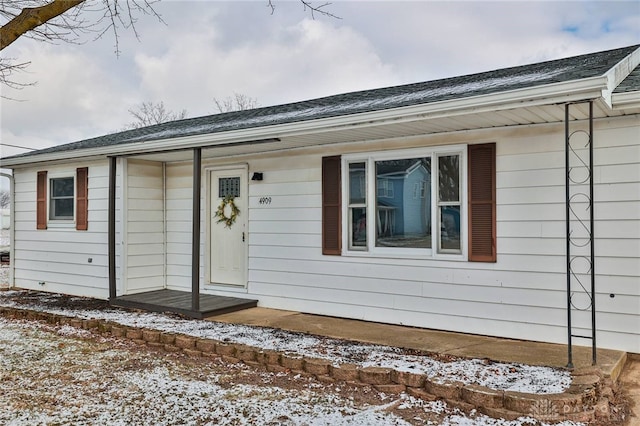 view of snow covered property entrance