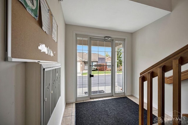 doorway with light tile patterned floors and mail boxes