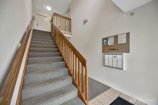 stairs with tile patterned flooring and a mail area