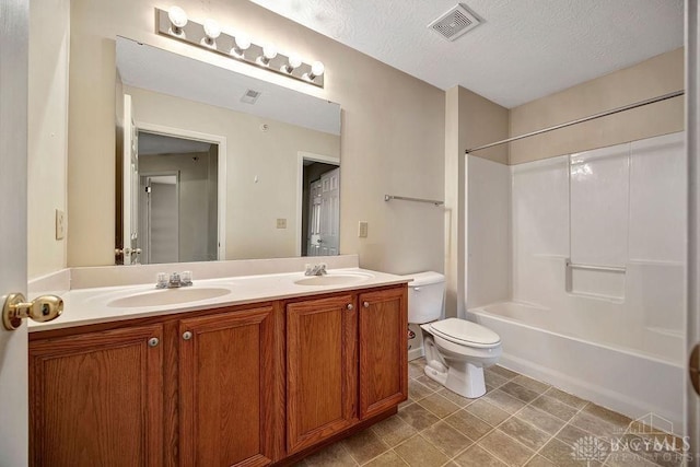 full bathroom featuring vanity, toilet, a textured ceiling, and bathing tub / shower combination