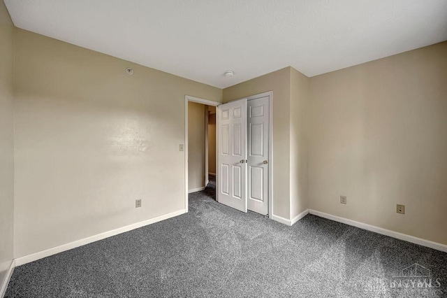 unfurnished bedroom featuring dark colored carpet