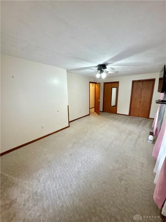 carpeted empty room with ceiling fan