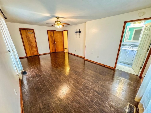 spare room featuring ceiling fan and dark wood-type flooring