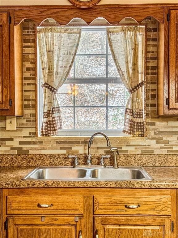 kitchen featuring tasteful backsplash and sink