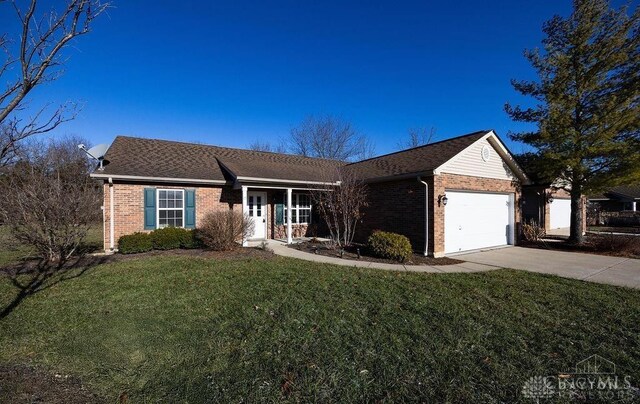 ranch-style house featuring a garage and a front lawn