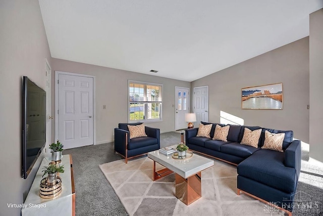 living area featuring lofted ceiling, baseboards, visible vents, and carpet flooring