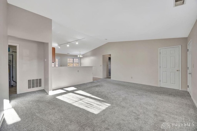 unfurnished living room with carpet, visible vents, and vaulted ceiling