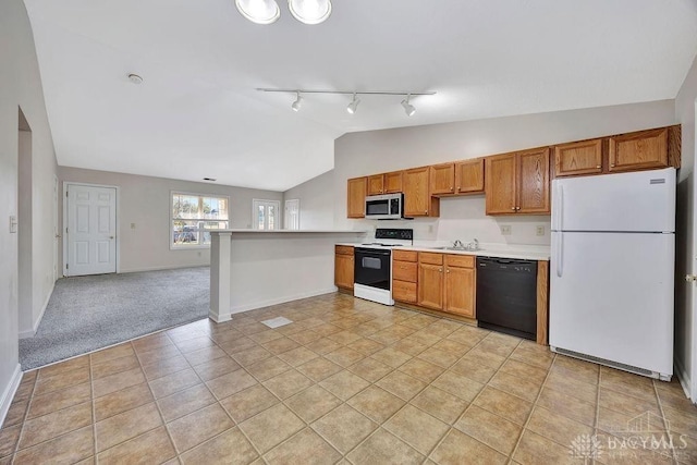 kitchen featuring black dishwasher, electric range, stainless steel microwave, freestanding refrigerator, and vaulted ceiling