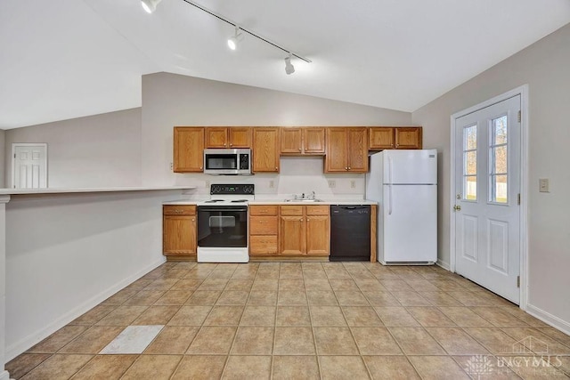 kitchen with black dishwasher, electric stove, stainless steel microwave, freestanding refrigerator, and a sink