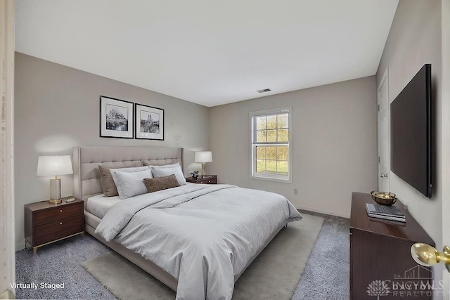 bedroom featuring baseboards and visible vents