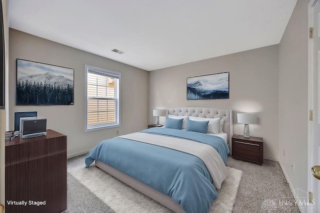 bedroom with light colored carpet, visible vents, and baseboards