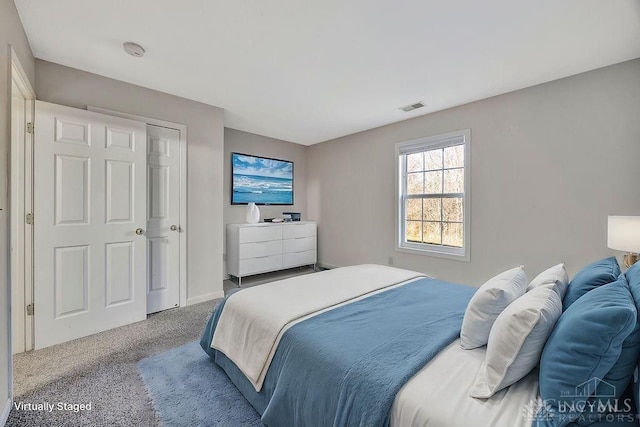 carpeted bedroom with baseboards and visible vents