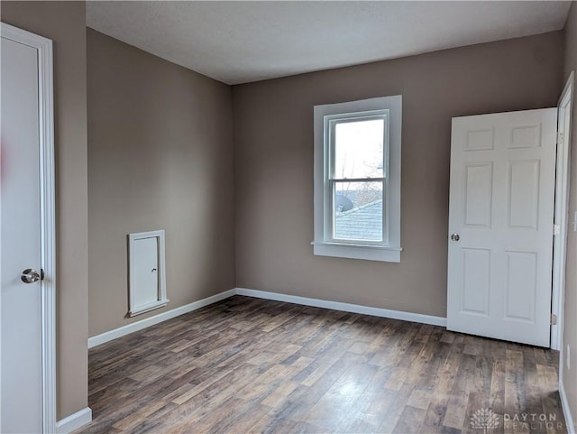 empty room featuring dark hardwood / wood-style floors