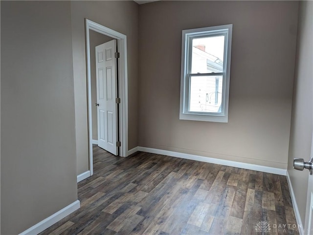 spare room with dark hardwood / wood-style floors