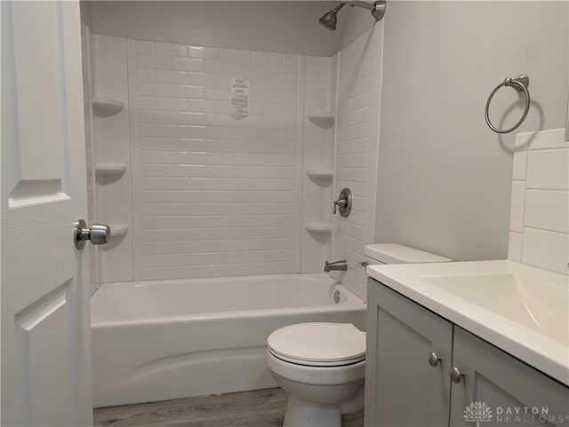 full bathroom featuring hardwood / wood-style floors, vanity, toilet, and tub / shower combination