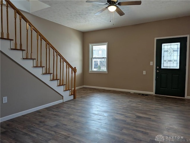 foyer featuring a textured ceiling, ceiling fan, and dark hardwood / wood-style floors