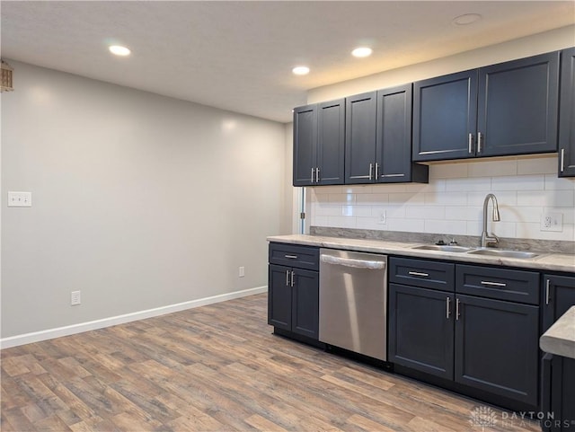 kitchen featuring hardwood / wood-style flooring, dishwasher, decorative backsplash, and sink