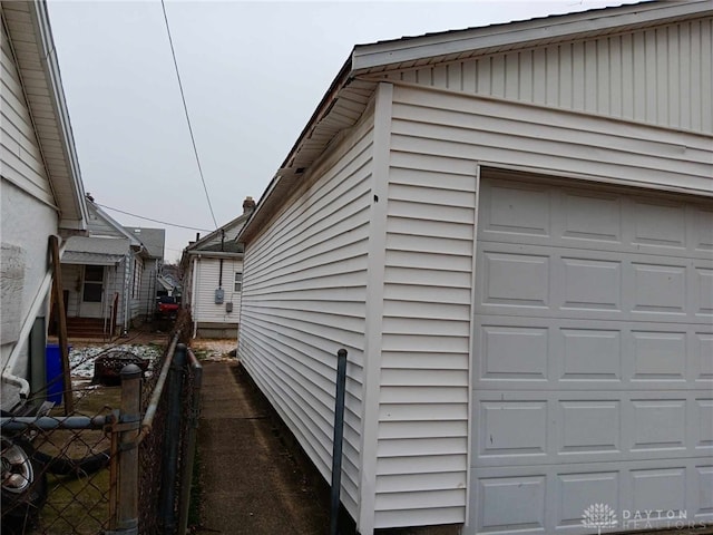 view of side of home featuring a garage