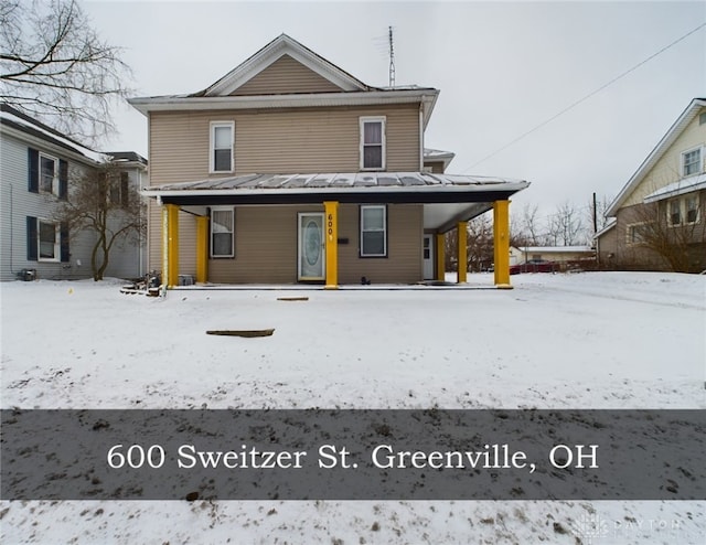 snow covered house with covered porch