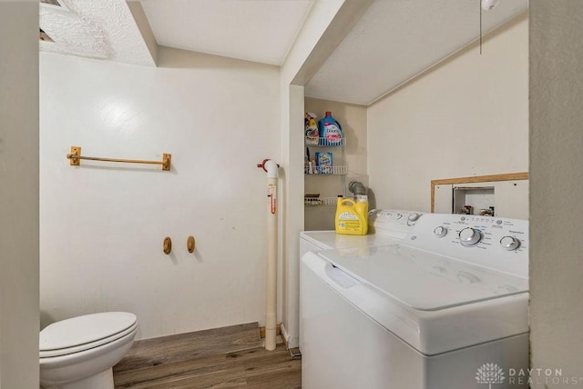 laundry room with dark hardwood / wood-style flooring and washer and dryer