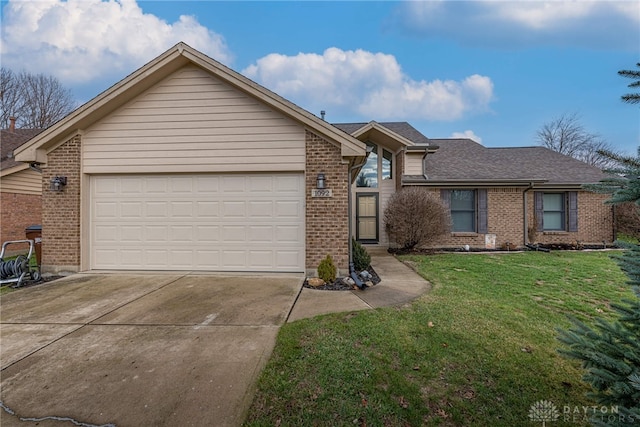 single story home featuring a garage and a front lawn