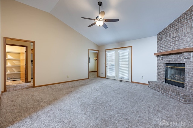 unfurnished living room with ceiling fan, light colored carpet, lofted ceiling, and a brick fireplace