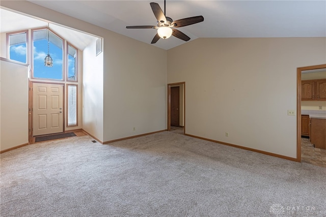 unfurnished living room with ceiling fan, light colored carpet, and high vaulted ceiling