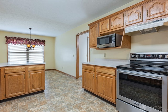 kitchen with a chandelier, appliances with stainless steel finishes, and hanging light fixtures