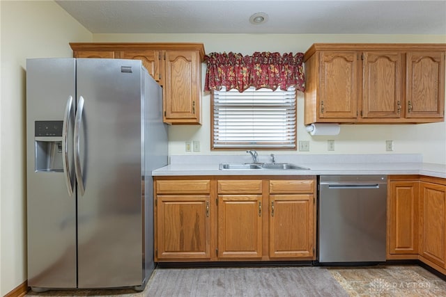 kitchen with sink, light hardwood / wood-style floors, and appliances with stainless steel finishes