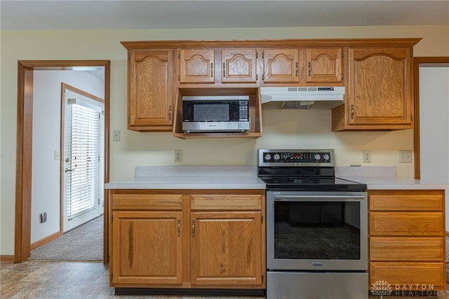 kitchen featuring light carpet and appliances with stainless steel finishes