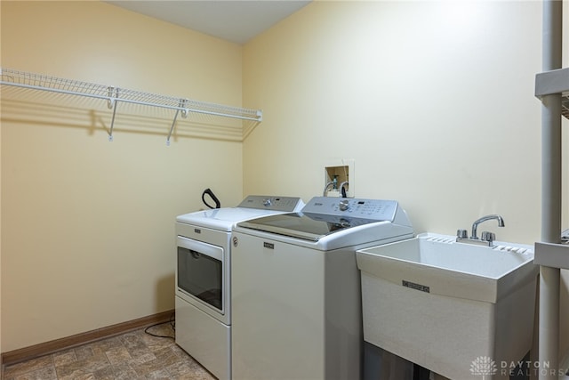 laundry room featuring washer and clothes dryer and sink