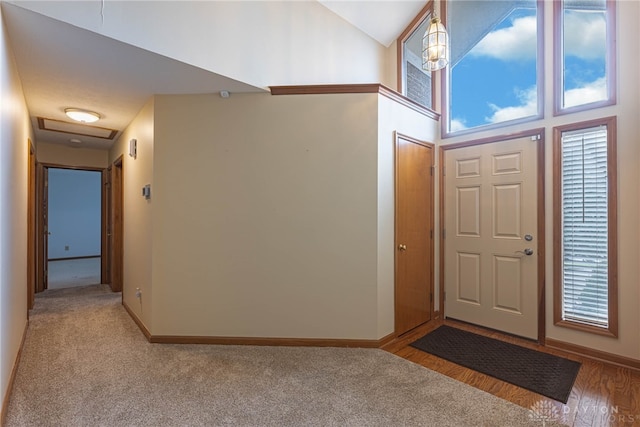 entrance foyer featuring a high ceiling and light wood-type flooring