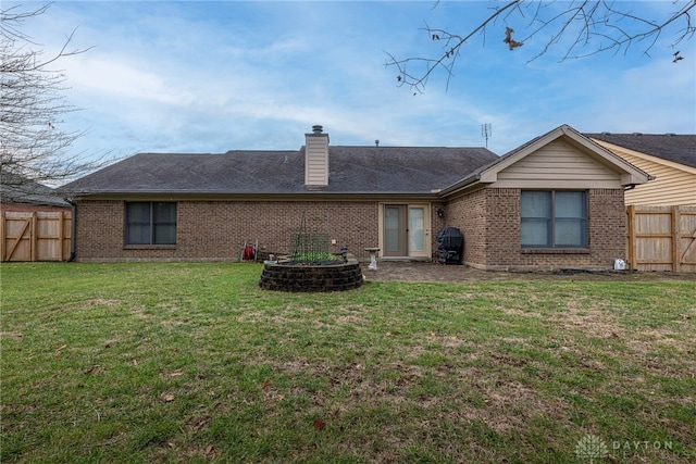 rear view of house with a yard