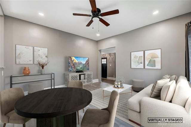 living room featuring light hardwood / wood-style floors and ceiling fan