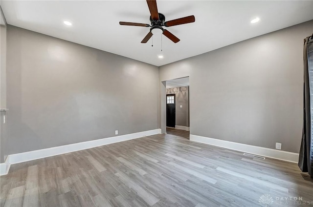 empty room with light hardwood / wood-style floors and ceiling fan