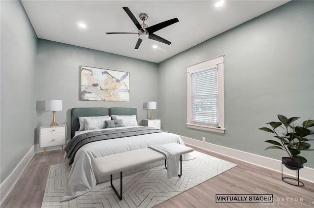 bedroom with ceiling fan and light hardwood / wood-style flooring