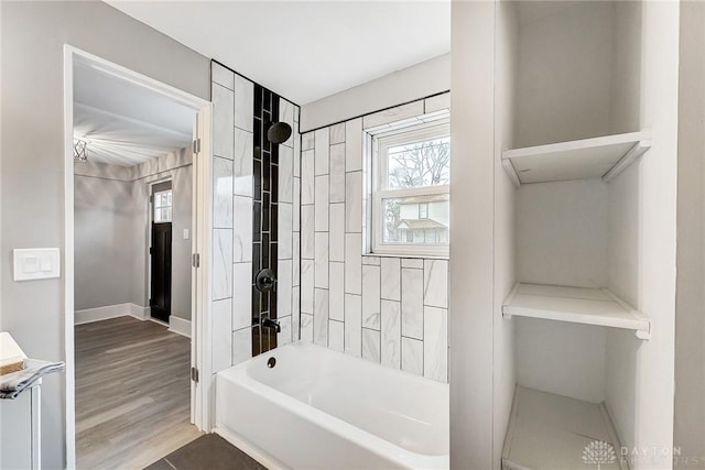 bathroom with vanity, wood-type flooring, and tiled shower / bath combo