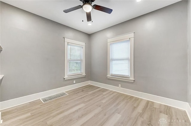 empty room with ceiling fan and light hardwood / wood-style floors