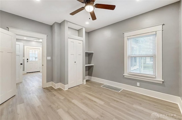 unfurnished room featuring light wood-type flooring and ceiling fan