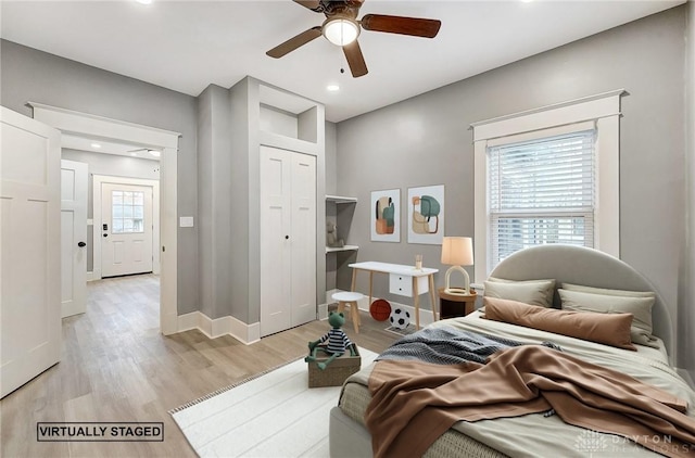 bedroom with a closet, ceiling fan, and light hardwood / wood-style flooring